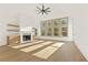 Bright living room featuring hardwood floors, vaulted ceilings and a view to the trees outside at 2410 Glade Overlook, Cumming, GA 30041