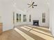 Bright living room with high ceilings, fireplace, and large windows offering scenic views at 2410 Glade Overlook, Cumming, GA 30041