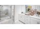 Bright bathroom showcasing double vanity and glass enclosed marble shower with built-in seat at 2453 Red Maple Se Xing # 118, Smyrna, GA 30080