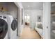 Convenient upstairs laundry room with modern washer and dryer units, and plenty of storage shelving at 2453 Red Maple Se Xing # 118, Smyrna, GA 30080