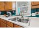 Close up of a kitchen sink and faucet with wood cabinets and tile backsplash at 2989 Abbotts Oak Way, Duluth, GA 30097