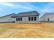 Spacious backyard with healthy lawn; features include a covered patio, well-maintained landscaping, and privacy at 811 Pineberry Ct, Grayson, GA 30017