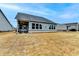 Wide view of the backyard with covered patio, showcasing the home's outdoor living space at 811 Pineberry Ct, Grayson, GA 30017