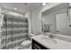 Clean bathroom with a shower, toilet, and a vanity with a mirror and ample counter space at 811 Pineberry Ct, Grayson, GA 30017