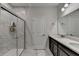 Modern bathroom featuring marble-look tile, a glass-enclosed shower, and a double vanity with light countertops at 811 Pineberry Ct, Grayson, GA 30017