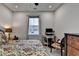 Bright bedroom with ceiling fan, patterned bedding and a large window overlooking the neighborhood at 811 Pineberry Ct, Grayson, GA 30017