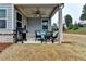 View of a charming covered patio with a ceiling fan, outdoor seating, and a grill, perfect for relaxing or entertaining at 811 Pineberry Ct, Grayson, GA 30017