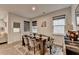 Bright dining area features wood floors, large windows, elegant table, and access to the outdoors at 811 Pineberry Ct, Grayson, GA 30017