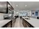 Open-concept kitchen featuring stainless steel appliances, sleek countertops, and dark wood cabinetry at 811 Pineberry Ct, Grayson, GA 30017