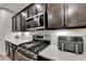 Close-up of modern kitchen appliances, including a gas stove and microwave, complemented by white countertops at 811 Pineberry Ct, Grayson, GA 30017