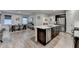 Modern kitchen with a large island, stainless steel appliances, and an adjacent dining area at 811 Pineberry Ct, Grayson, GA 30017