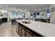 Modern kitchen island featuring a stainless steel sink with an open-concept to the living and dining areas at 811 Pineberry Ct, Grayson, GA 30017