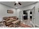 Living room with view to the kitchen has a cozy brown sofa, patterned rug, and adjacent French doors at 811 Pineberry Ct, Grayson, GA 30017