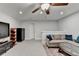 Open living room featuring neutral tones, comfortable sectional, and ceiling fan at 811 Pineberry Ct, Grayson, GA 30017