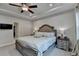 Well-lit main bedroom with a large bed, ceiling fan, side tables, and neutral-colored walls at 811 Pineberry Ct, Grayson, GA 30017