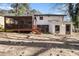 A home's backyard featuring a raised wooden patio and a detached shed at 989 Queen Elizabeth Way, Morrow, GA 30260