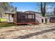 A home's backyard featuring a raised wooden patio and a detached shed at 989 Queen Elizabeth Way, Morrow, GA 30260