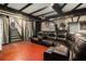 Large basement with dark brown leather sectional, drop lighting, and black wood trim at 989 Queen Elizabeth Way, Morrow, GA 30260
