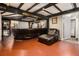 Large basement with dark brown leather sectional, drop lighting, and black wood trim at 989 Queen Elizabeth Way, Morrow, GA 30260