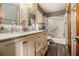 Bathroom with double sink vanity, marble tile shower, and modern fixtures at 989 Queen Elizabeth Way, Morrow, GA 30260