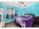 Cozy bedroom featuring bright blue walls, hardwood floors, and a ceiling fan with lighting at 989 Queen Elizabeth Way, Morrow, GA 30260