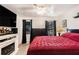 Comfortable main bedroom with a red comforter, flatscreen TV, and backyard view at 989 Queen Elizabeth Way, Morrow, GA 30260