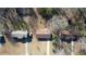 Aerial view of the house among surrounding homes with mature trees and driveways at 11 Grove Ln, Hampton, GA 30228