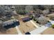 Aerial view showcasing the property surrounded by mature trees and neighboring houses at 11 Grove Ln, Hampton, GA 30228
