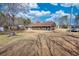 Spacious backyard showcasing a well-maintained lawn, mature trees, and the home's exterior at 11 Grove Ln, Hampton, GA 30228