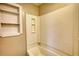 Bathroom featuring a bathtub and shower with a white surround and built in shelves at 11 Grove Ln, Hampton, GA 30228