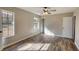 Bedroom featuring wood-look floors, neutral walls, and natural light through two windows at 11 Grove Ln, Hampton, GA 30228