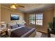 Bedroom with large window with view and decorative snow-capped mountain photograph on the wall at 11 Grove Ln, Hampton, GA 30228