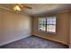 Bedroom with large window providing plenty of natural light and wall-to-wall carpeting at 11 Grove Ln, Hampton, GA 30228