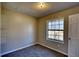 Simple bedroom design with a window, neutral paint, and a door to the hallway at 11 Grove Ln, Hampton, GA 30228