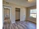 Bedroom with hardwood floors, a closet, and natural lighting at 11 Grove Ln, Hampton, GA 30228