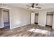 Bright bedroom featuring wood-look floors, ceiling fan and ample closet space at 11 Grove Ln, Hampton, GA 30228