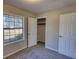 Bedroom featuring carpet floors, a closet, and a window for natural lighting at 11 Grove Ln, Hampton, GA 30228