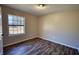 Bedroom featuring hardwood floors, a window, and neutral paint at 11 Grove Ln, Hampton, GA 30228