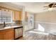 Dining room with stainless steel dishwasher and sink with doors to the backyard and wood floor at 11 Grove Ln, Hampton, GA 30228