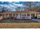 Delightful brick home with a welcoming white porch, accented by fresh landscaping and a lush lawn at 11 Grove Ln, Hampton, GA 30228