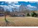 Charming single-story brick house with a white picket fence porch and a wide front yard at 11 Grove Ln, Hampton, GA 30228