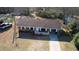 Overhead view of a brick house with white trim, small porch, and landscaping at 11 Grove Ln, Hampton, GA 30228