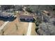Aerial view of the single-Gathering home with mature trees and front yard driveway at 11 Grove Ln, Hampton, GA 30228