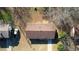 Aerial shot of a single-Gathering home with brown roof, surrounded by trees and a front drive at 11 Grove Ln, Hampton, GA 30228