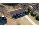 Aerial view of the single-Gathering home with mature trees and front yard driveway at 11 Grove Ln, Hampton, GA 30228