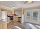 Bright kitchen with stainless steel appliances, wood cabinets, and glass paneled french doors to back at 11 Grove Ln, Hampton, GA 30228