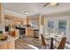 Eat-in kitchen with stainless steel appliances, stone backsplash, and wood cabinets at 11 Grove Ln, Hampton, GA 30228