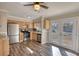 Well-lit kitchen with stainless steel appliances, a stone backsplash, and hardwood floors at 11 Grove Ln, Hampton, GA 30228