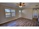 Bright and airy living room featuring stylish hardwood floors and a large window at 11 Grove Ln, Hampton, GA 30228