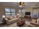 Comfortable living room with a cozy sofa, armchairs, and large window letting in natural light at 11 Grove Ln, Hampton, GA 30228